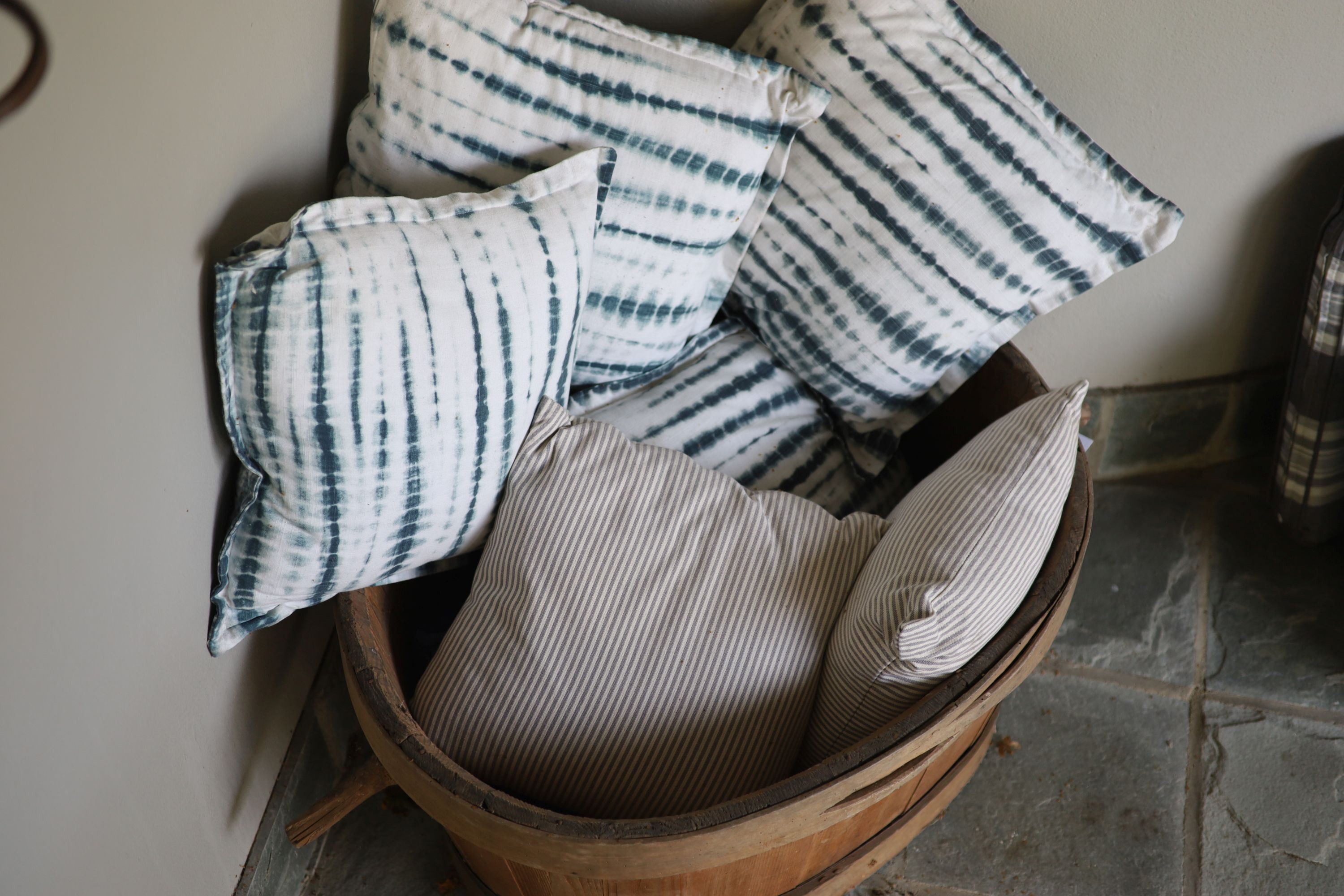 A French coopered pine grape bin, width over handles 97cm, and six assorted cushions